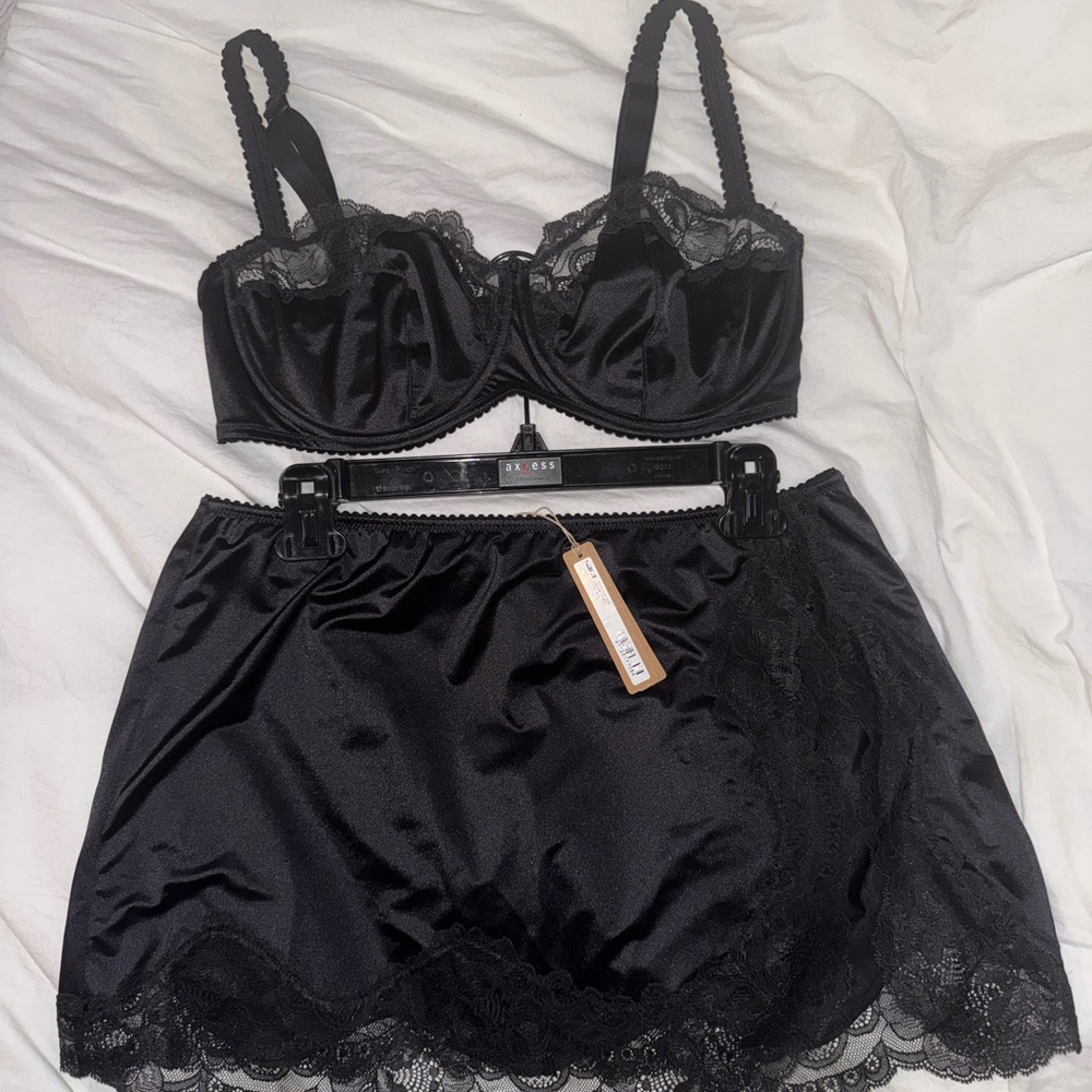 SKIMS Black Satin Skirt and Lace Bra Set.